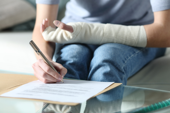 injured person signing personal injury paperwork 